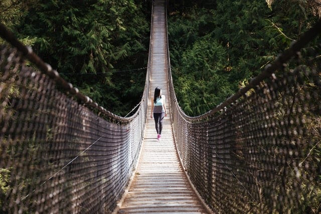 lady crossing a bridge