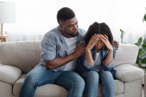 a person holds another after recognizing signs to get sober