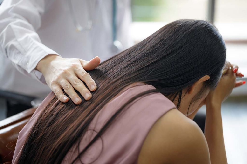 a doctor comforts someone struggling with chronic pain and addiction