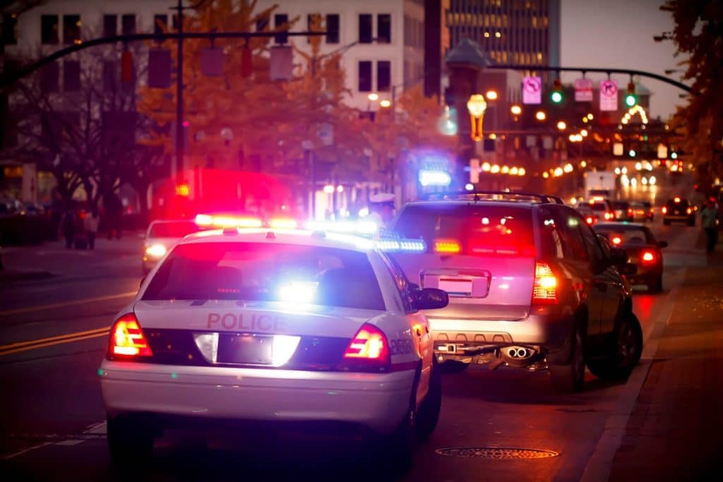 a few police cars with their lights on possibly enforcing dui and dwi laws in wa state