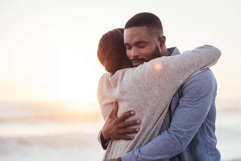two people hug as they making amends during recovery
