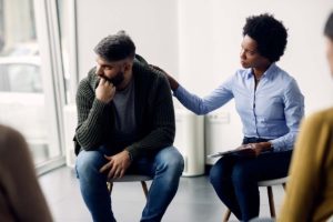 a person looks outward from a group after dealing with Opioid Withdrawal Symptoms