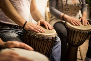 a group plays hand drums during Music Therapy Services