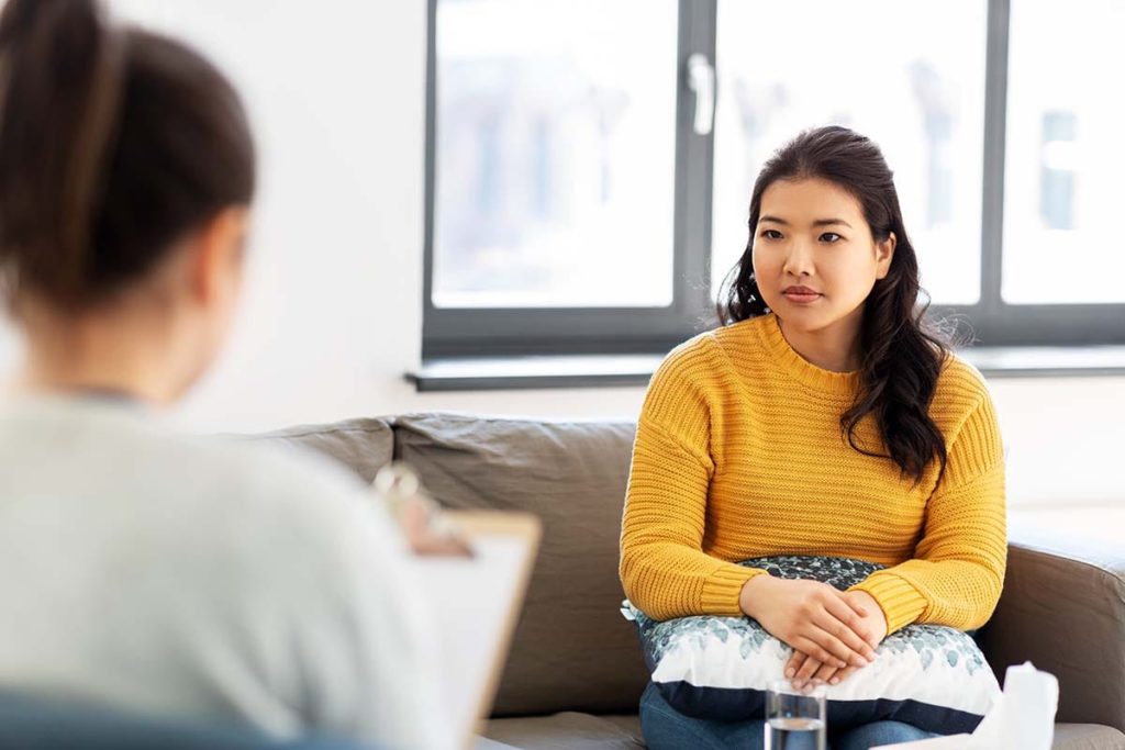 a person talks to a therapist in an Outpatient Addiction Treatment program