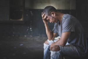 a man struggles not to relapse while experiencing xanax withdrawal symptoms without help