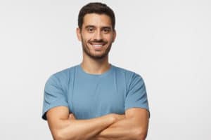 a person crosses their arms and smiles after preventing relapse