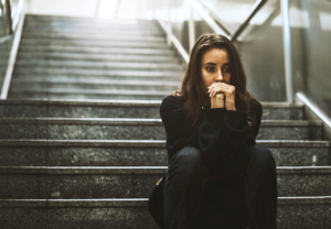 a person sits on steps outside wondering is fentanyl deadly