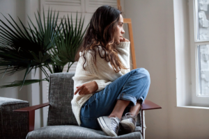 a person sits in a chair thinking of coping strategies for anxiety