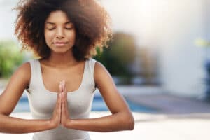 a woman practices meditative therapy in recovery