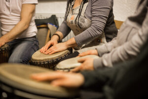 a music therapy group benefits from group drumming