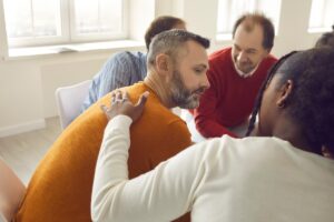 people in group therapy discussing how can dialectical behavior therapy help