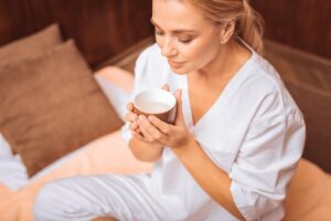 person drinking herbal tea as one of many self-care activities to cope with anxiety