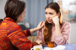 two concerned people discussing signs of prescription drug abuse in a friend