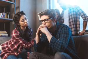 person comforting a companion at home after recognizing signs of co-occurring disorders in a friend